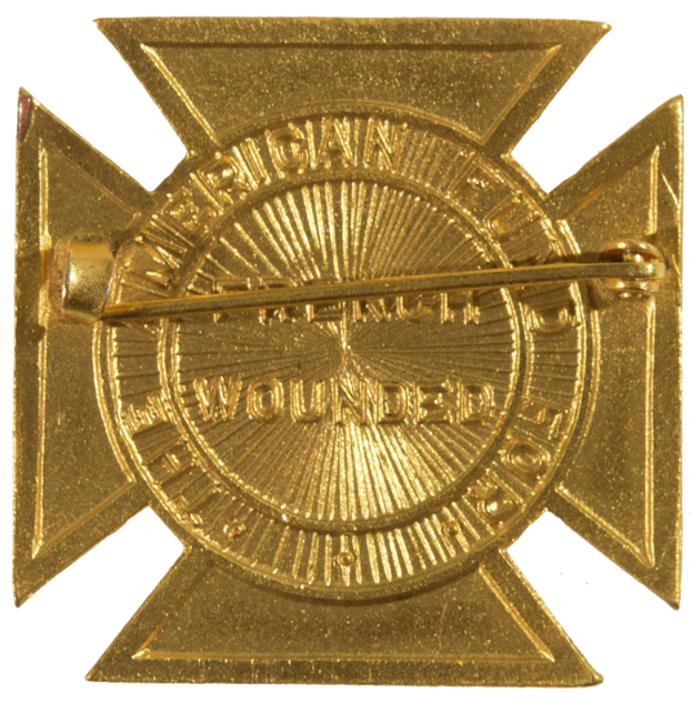 Gold American Fire Department badge with a star insignia, centered in the image with text on it.